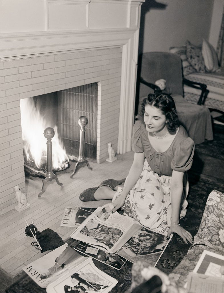 Detail of Young Woman Looking at Magazines by Corbis
