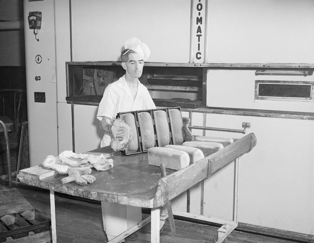 Detail of Man Taking Bread Loaves from Oven by Anonymous