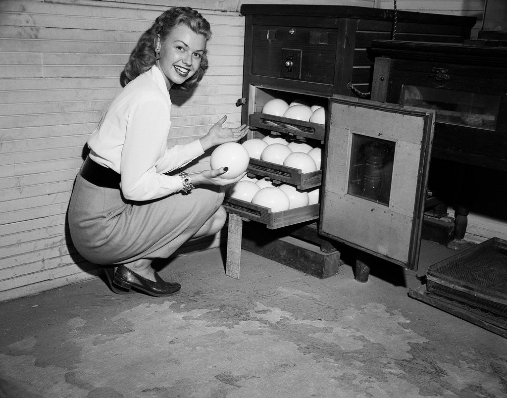 Detail of Woman Pull Ostrich Eggs from Incubator by Anonymous