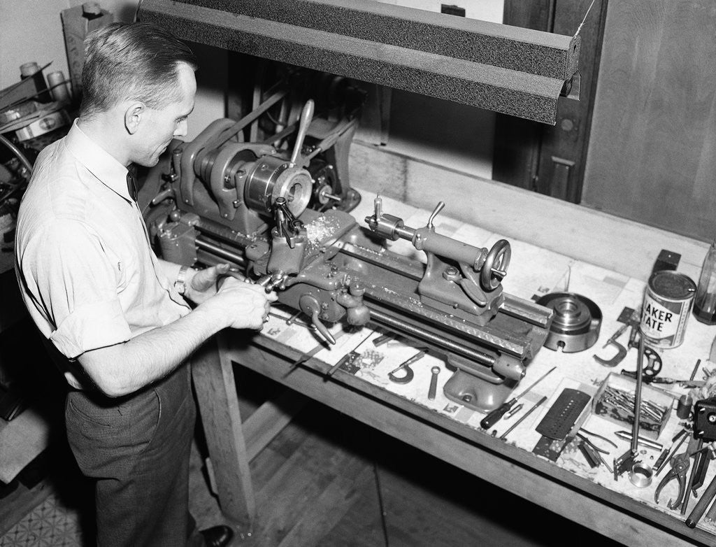 Detail of Man Working with Lathe in Basement Workshop by Anonymous
