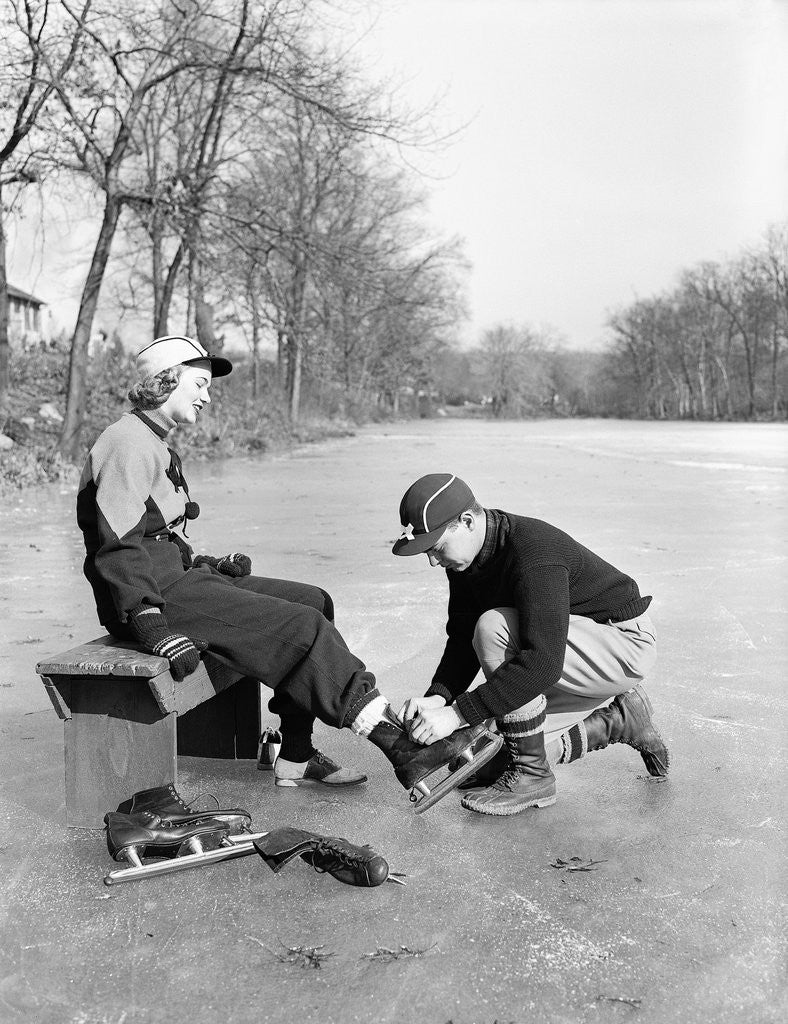 Detail of Man Putting on Woman's Ice Skates by Anonymous