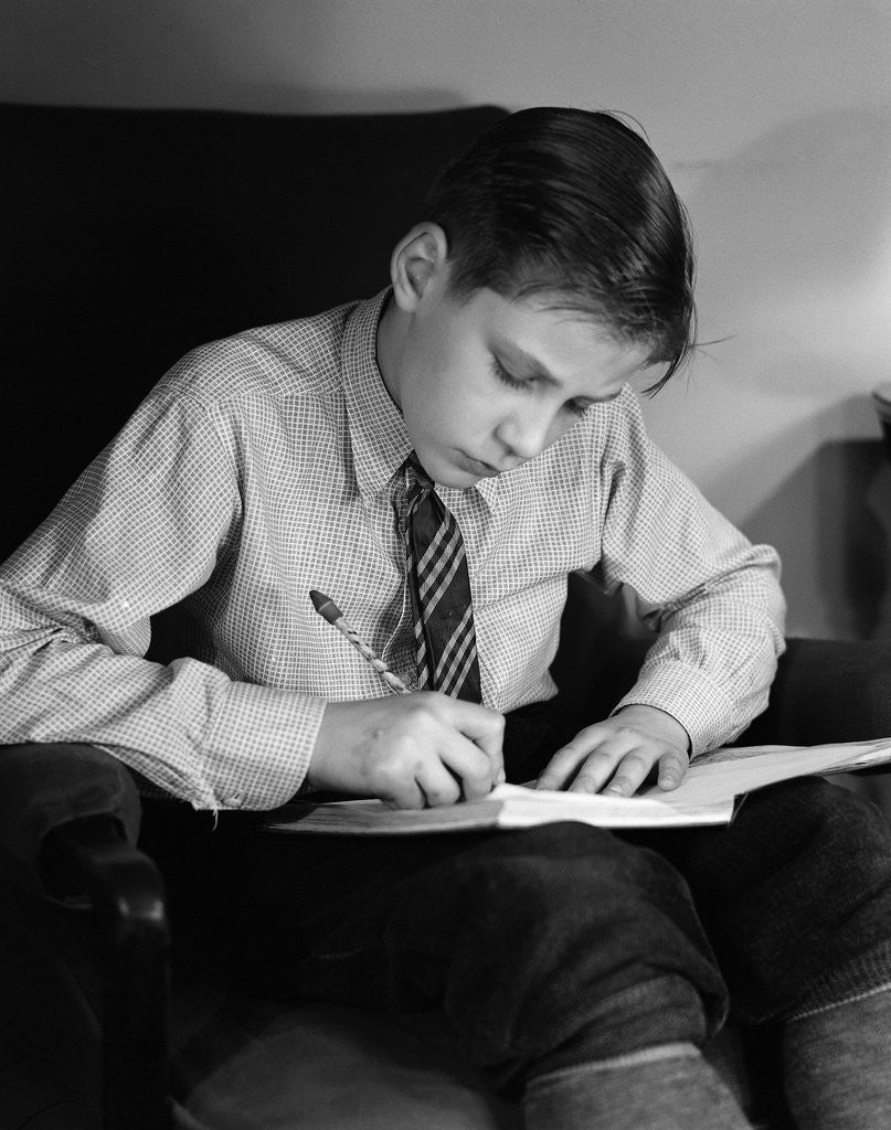 Detail of Seated Boy Doing Homework by Corbis