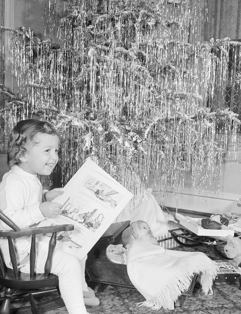Detail of Girl Sitting Beside Christmas Tree by Anonymous
