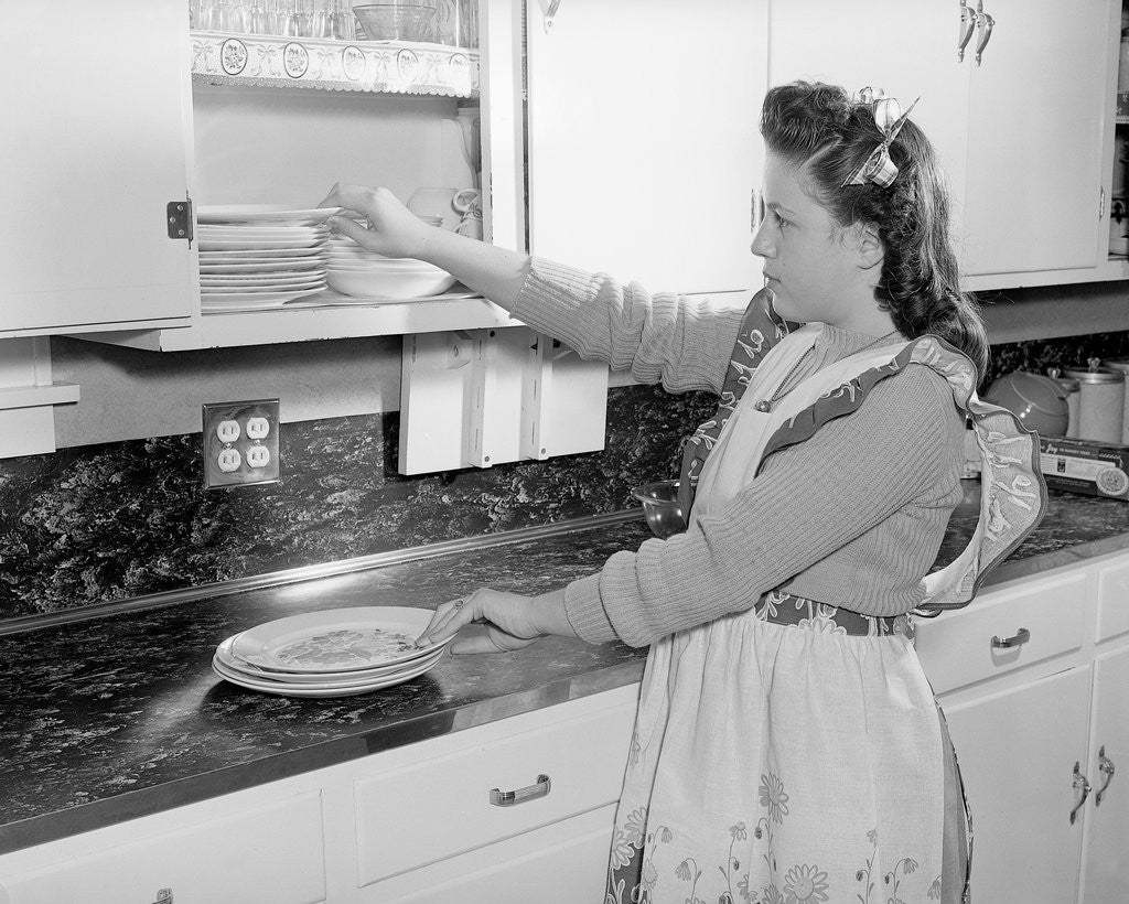Detail of Woman Putting Dishes In Cabinet by Anonymous