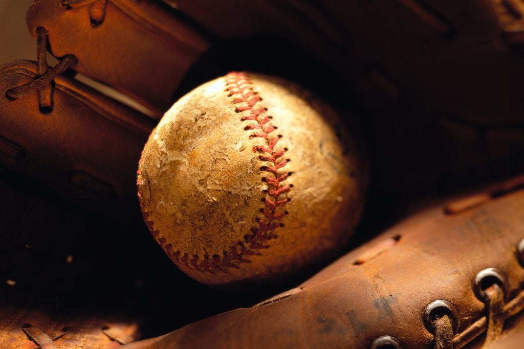 Detail of Old Baseball in Glove by Corbis