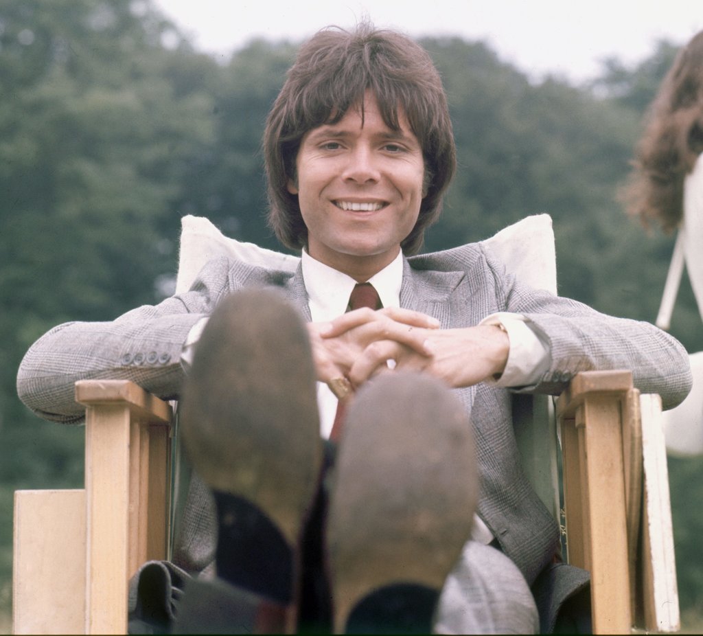 Detail of Cliff Richard relaxing between takes on 'Take Me High' by Staff