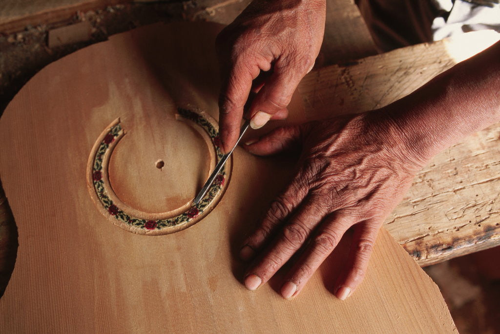 Detail of Carving a Guitar Face by Anonymous