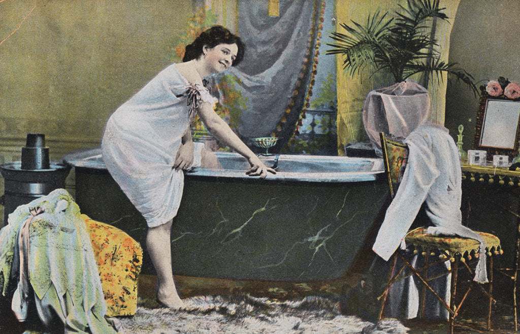 Woman Testing Water Temperature in Bathtub by Corbis