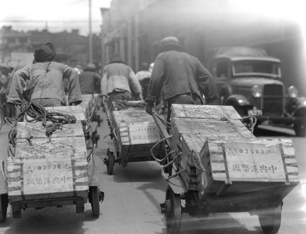 Detail of Chinese Men Pulling Heavy Loads of Silver Bullion by Corbis