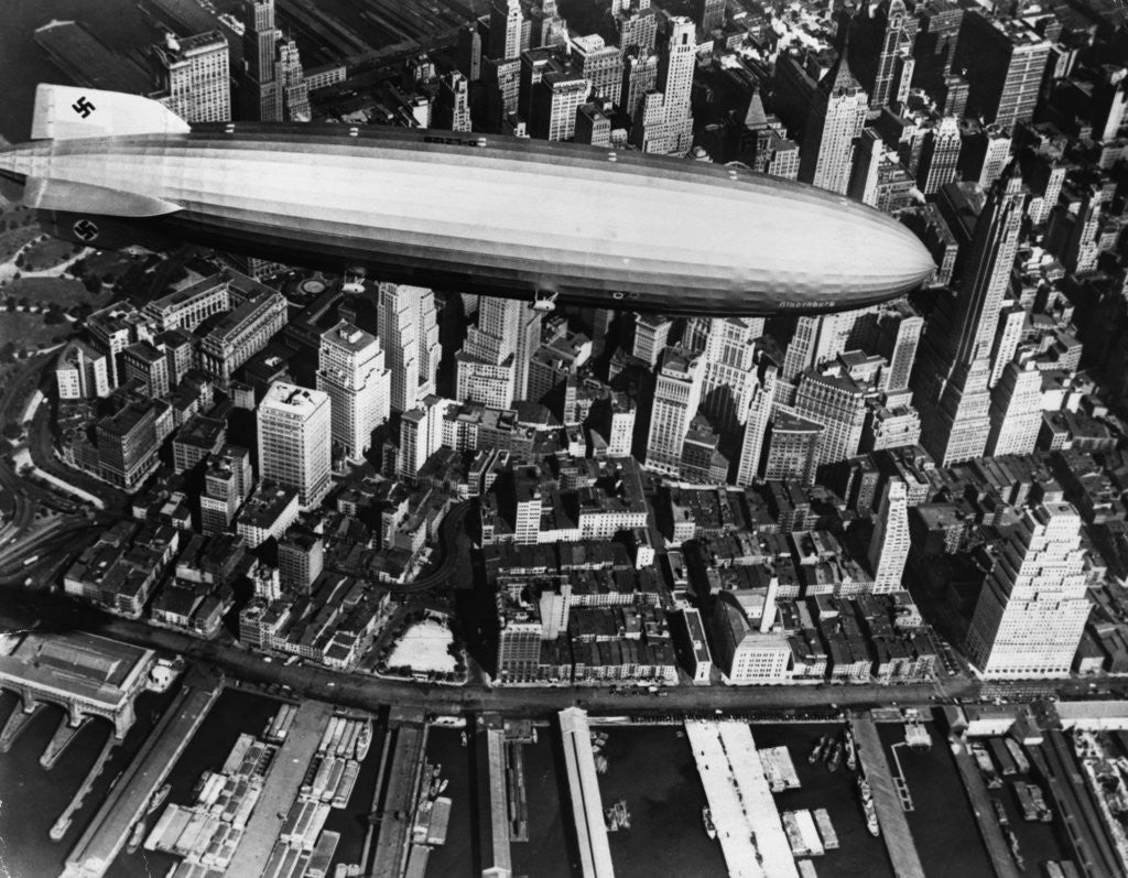 Detail of The German airship, the Hindenburg, above Manhattan, New York in 1936, on its way to its berth at Lakehurst , New Jersey, the same place where it inexplicably burst into flames the next year. by Corbis