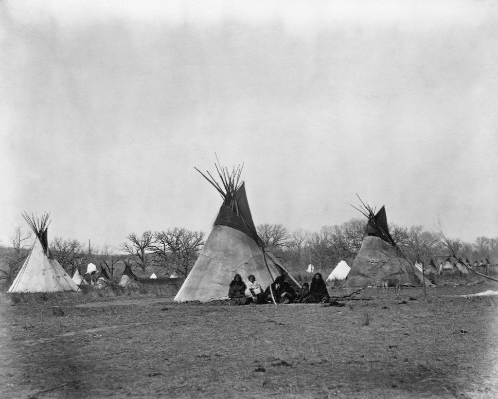 Detail of A Native American Family Sits Outside Their Teepee by Corbis