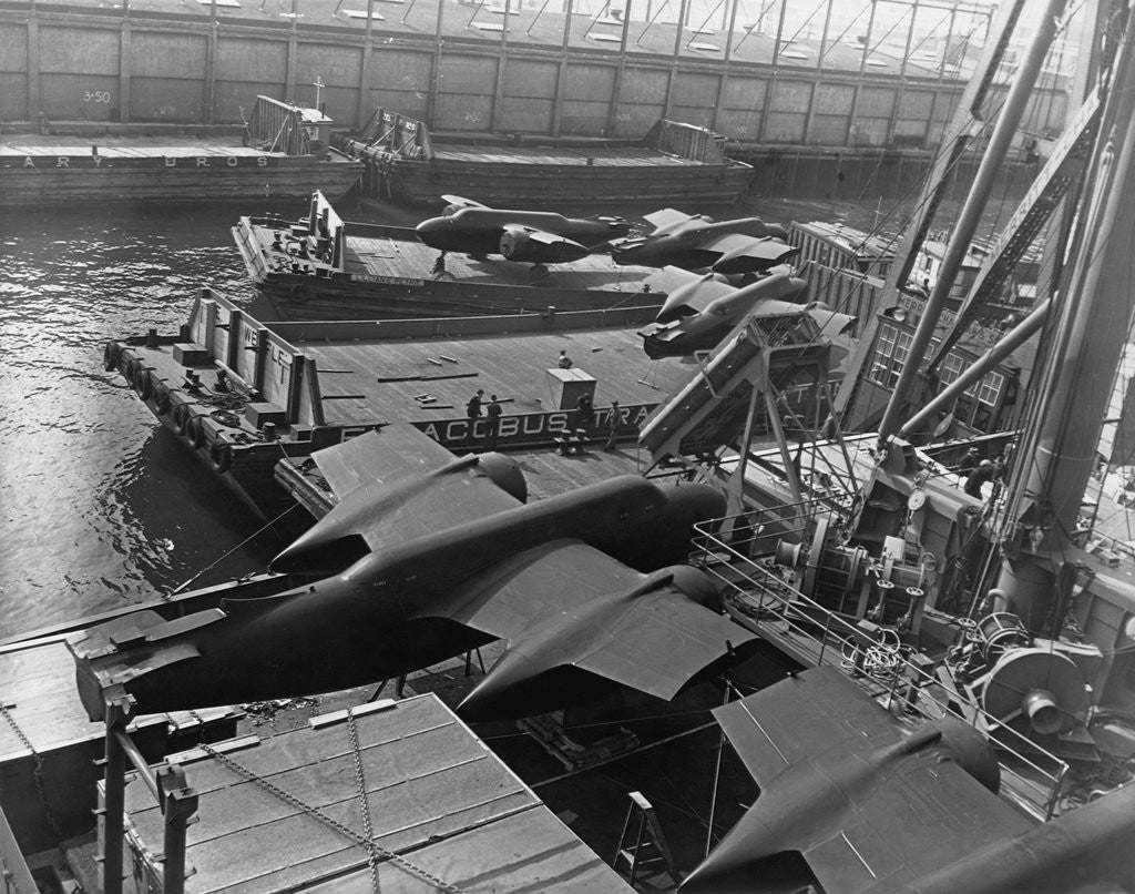 Detail of Heavy bombers on barges awaiting loading onto cargo vessel in New York harbor for shipment under provisions of the lend-lease by Anonymous