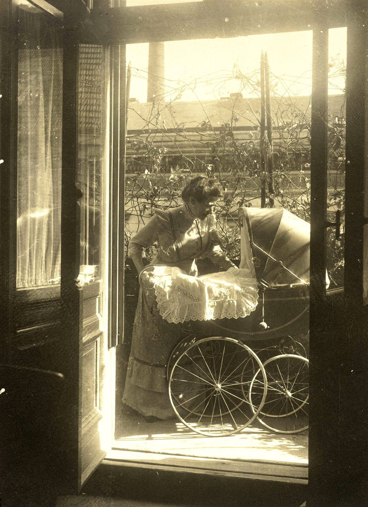 Detail of Unidentified woman standing near a pram on a balcony of the house Friedrichstrasse Berlin, Germany by Waldemar Titzenthaler