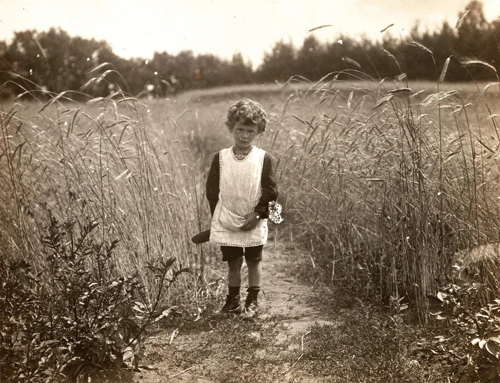 Detail of Eckart Titzenthaler, son of the photographer, standing in a field by Waldemar Titzenthaler