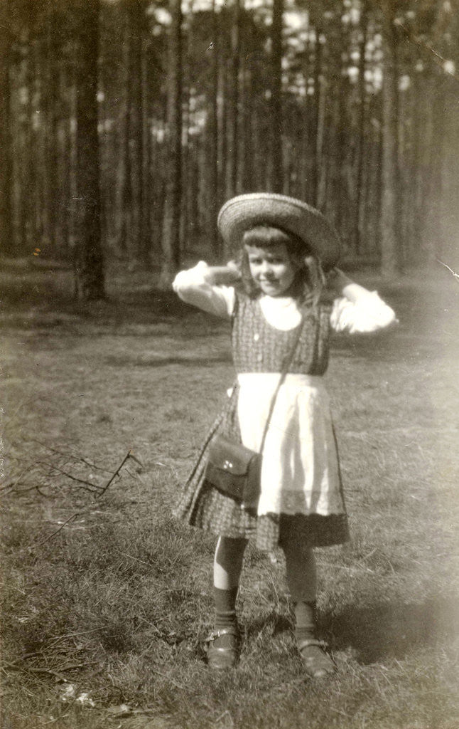 Detail of Marba Titzenthaler, daughter of the photographer, standing in front of a forest by Waldemar Titzenthaler