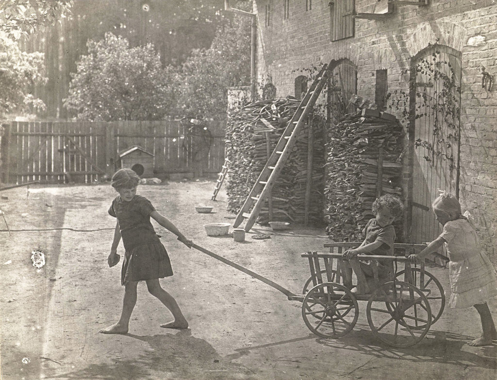 Detail of Marba and Eckart Titzenthaler, children of the photographer, girl in the yard playing with a cart by Waldemar Titzenthaler