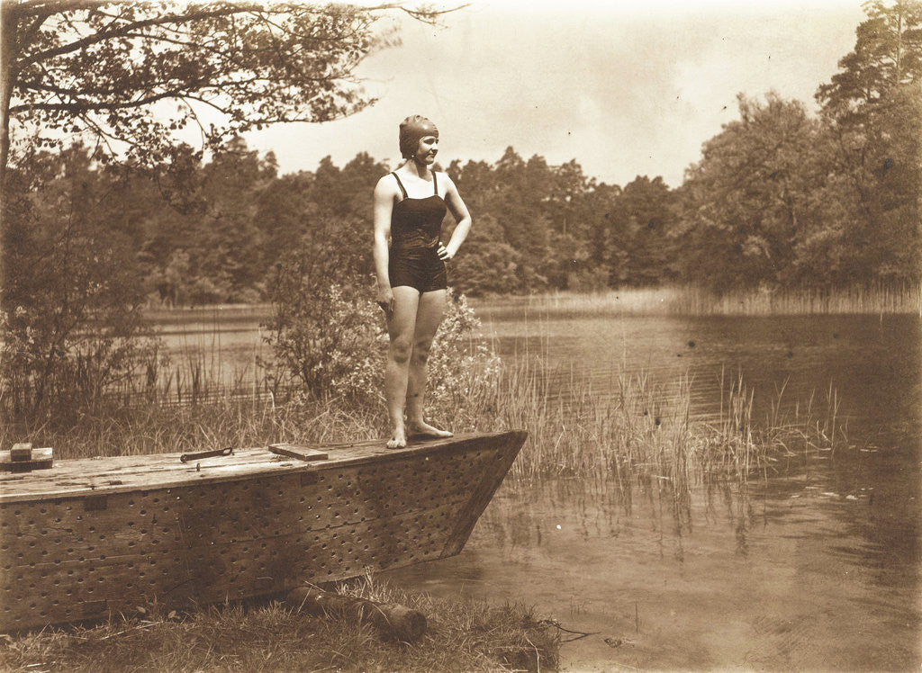 Detail of Unidentified young woman in swimsuit on a rowing boat standing on the edge of a lake by Waldemar Titzenthaler