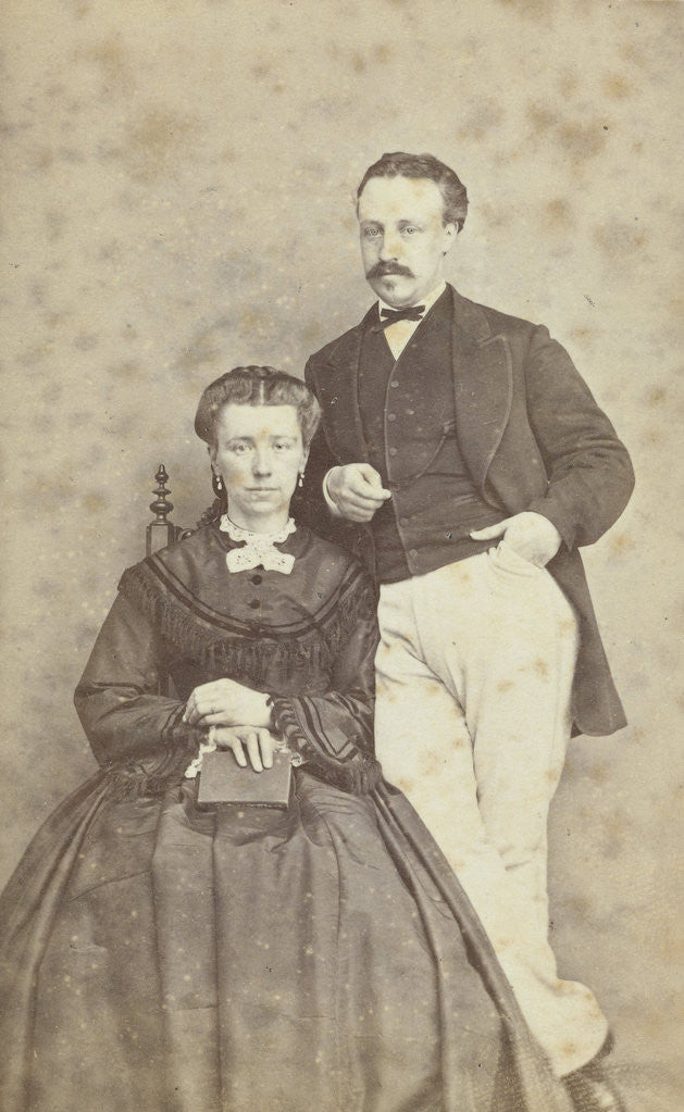 Detail of A seated woman with a book in her hands, leaning on her chair, a man in white trousers, one hand in his pocket by F.D. van Rosmalen & Zoon