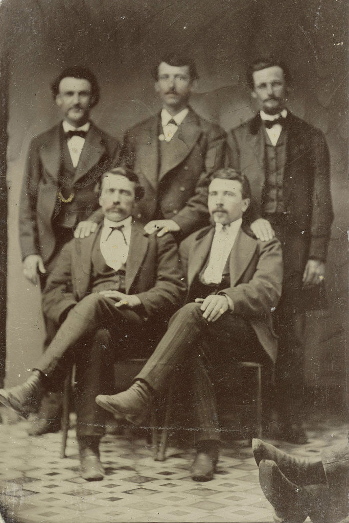 Detail of Group portrait of five men, standing and sitting in a studio (right two feet of another person) by Anonymous