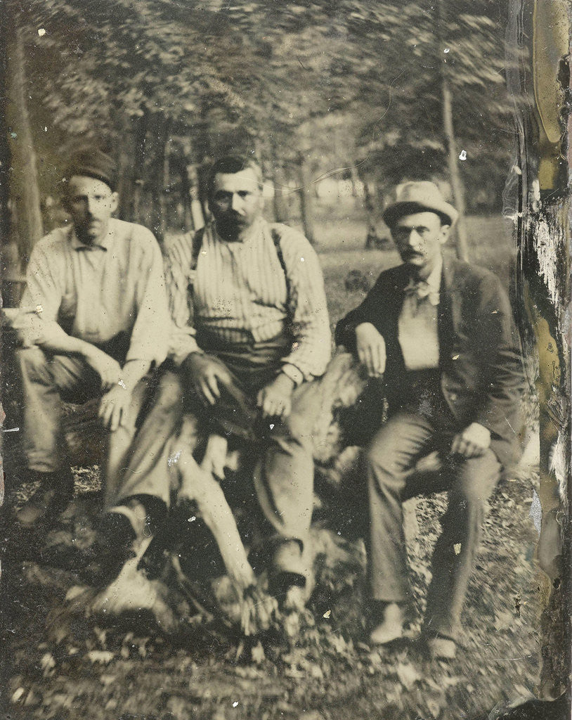Detail of Portrait of three men sitting on a tree stump? In a forest by Anonymous