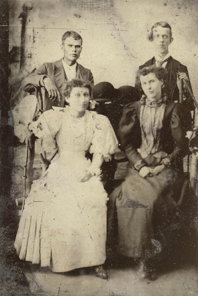 Detail of Portrait of two men and two women standing and sitting in front of a painted backdrop, lighthouse by Anonymous