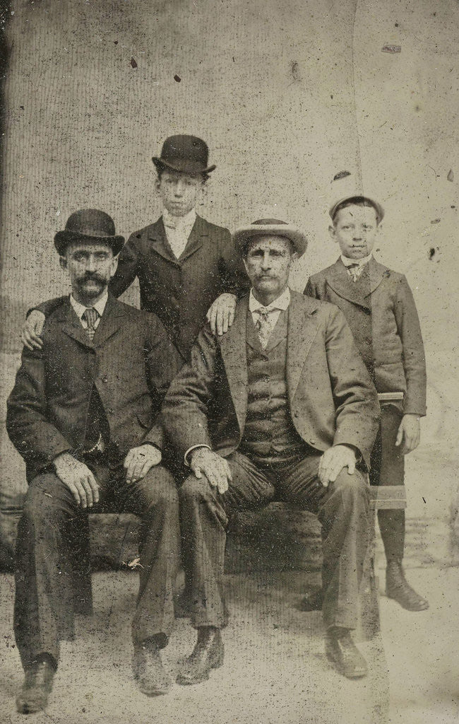 Detail of Portrait of two men and two boys, standing and sitting in front of a painted backdrop (pond?) by Anonymous