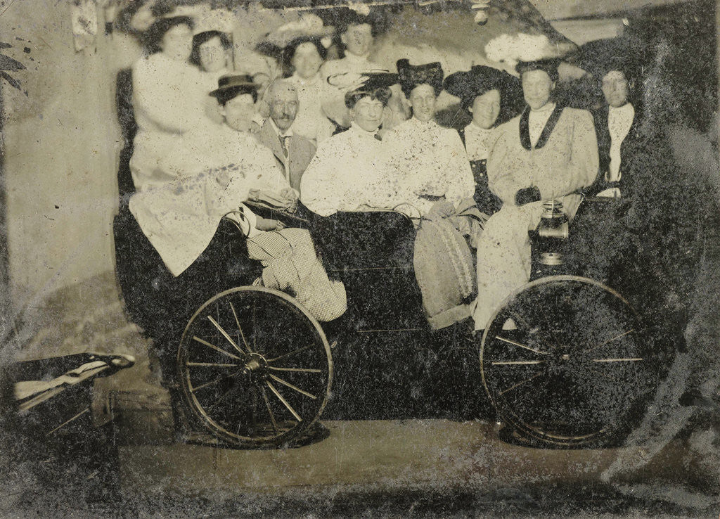 Detail of Group portrait of ten women and a man huddled in a carriage in a studio by Anonymous