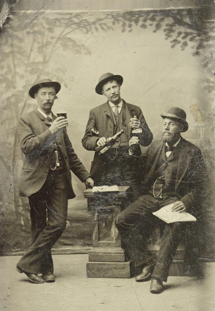 Detail of Portrait of three men with bottle and glasses, standing and sitting in front of a painted backdrop (trees) by Anonymous
