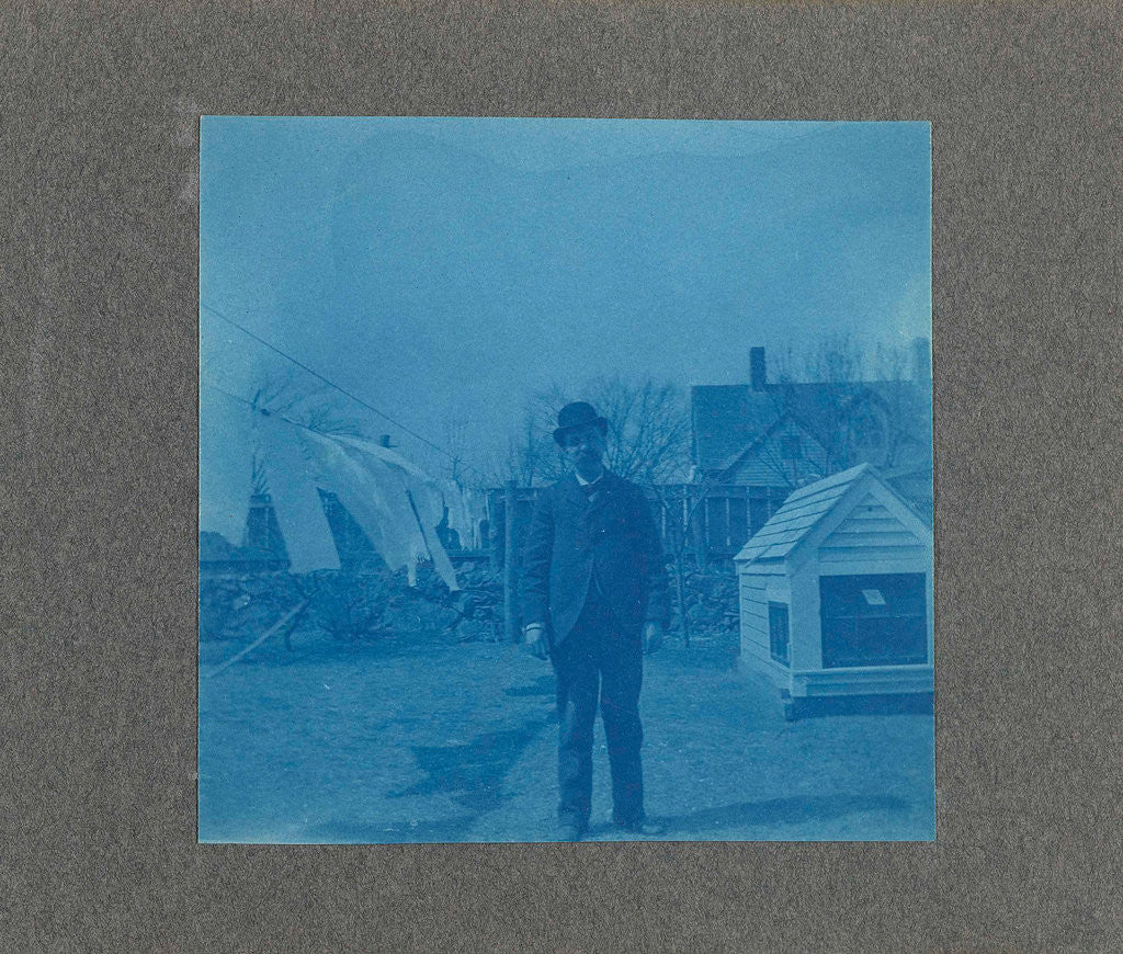 Detail of Man standing on a clothesline in a garden, USA by Anonymous