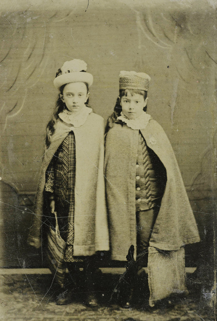Detail of Portrait of two girls with hats and capes, standing in a studio setting by Anonymous