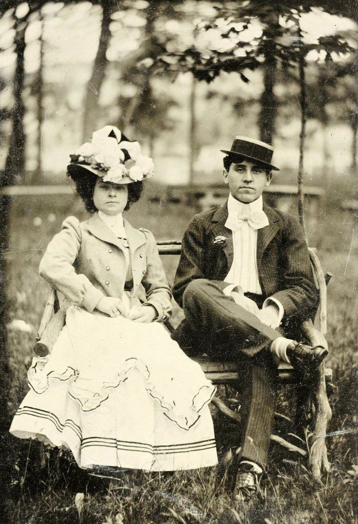 Detail of Portrait of a man and woman sitting on a bench in a forest or park setting by Anonymous