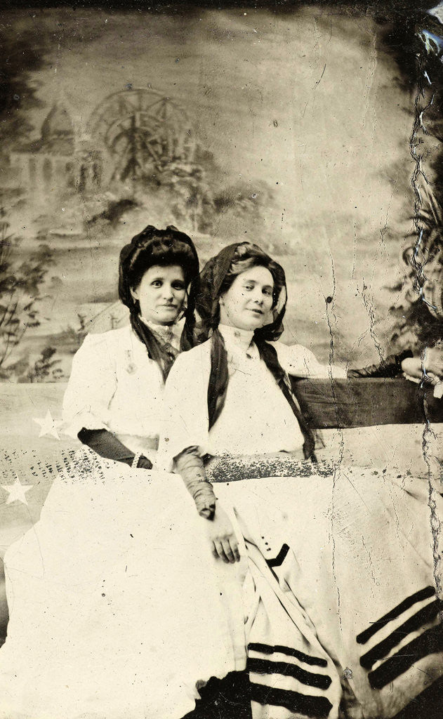 Detail of Portrait of two women sitting on a bench in front of a painted backdrop (chapel or church (?) In a lake), in the left part of the American flag by Anonymous