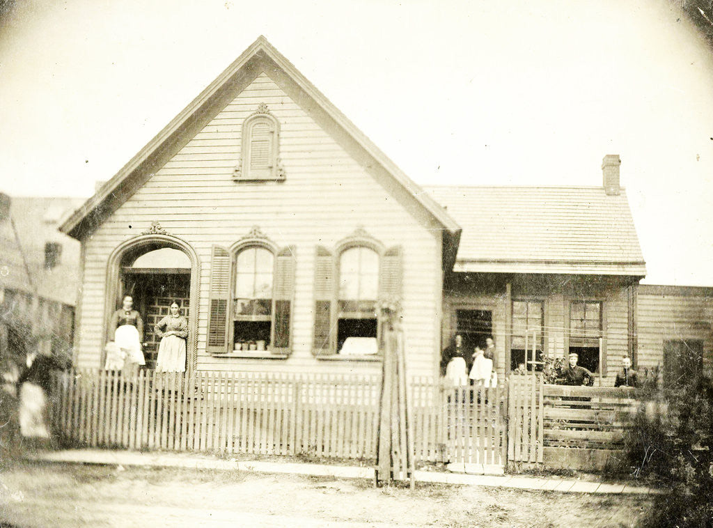 Detail of View of a wooden house with about nine people before or standing in doorways, United States by Anonymous