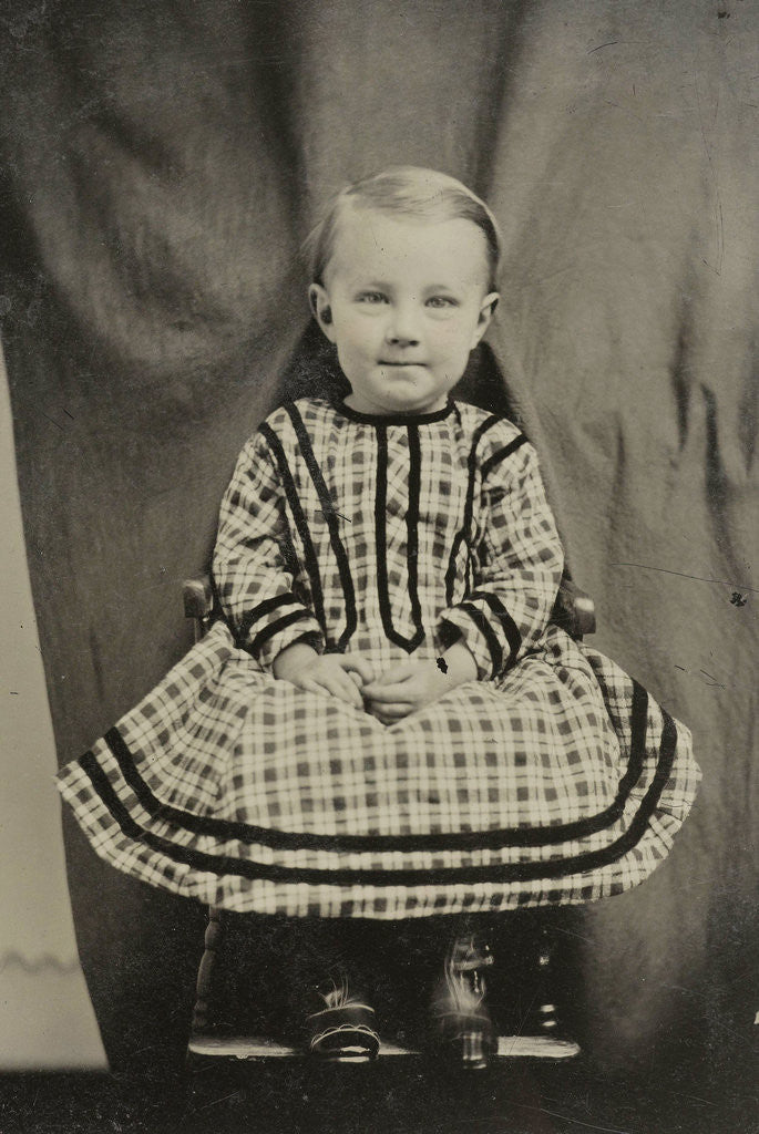 Detail of Portrait of a child sitting on a chair in a studio setting by Anonymous