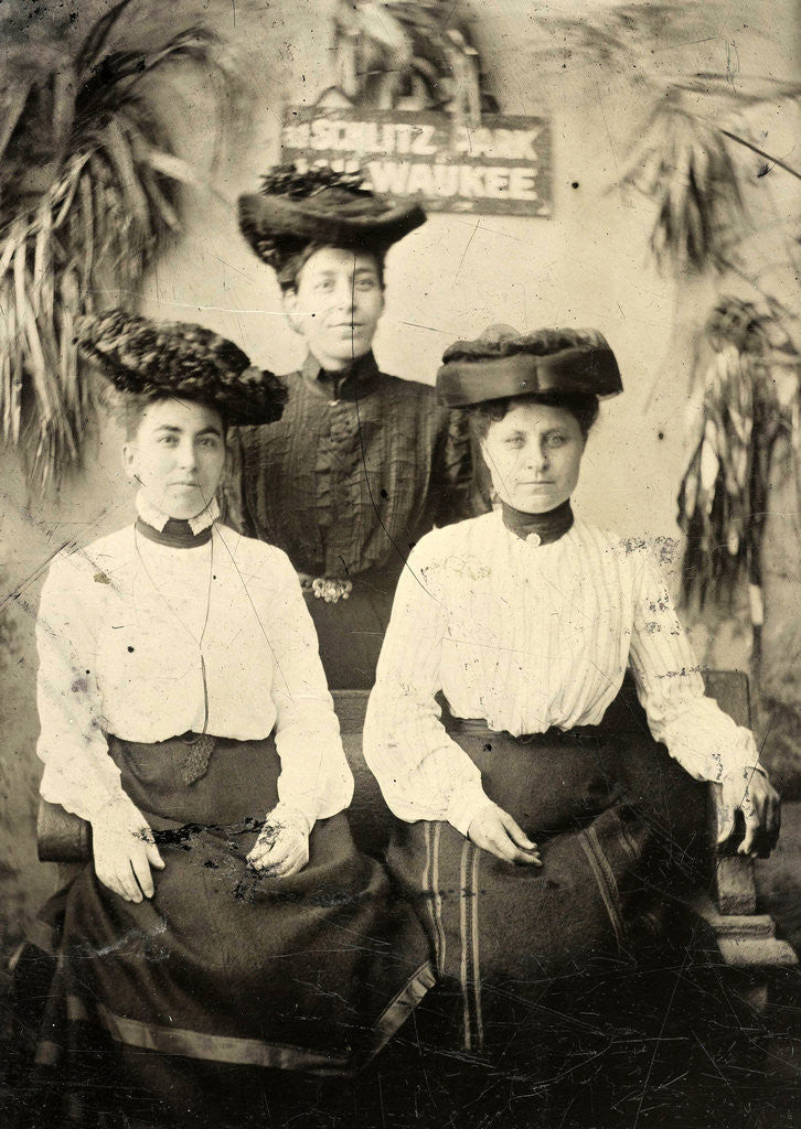 Detail of Portrait of three women standing and sitting in a studio setting, and behind them a sign that read AT SCHLITZ PARK MILWAUKEE by Anonymous