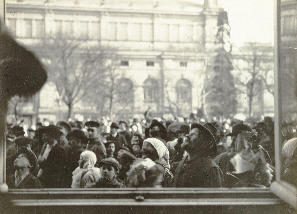 Detail of People crowd seen through the window of a house by Anonymous