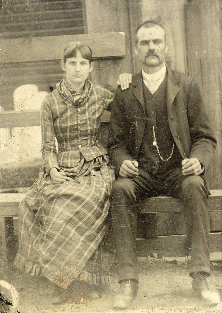 Detail of Portrait of a man and a woman sitting on a bench in front of their house (?) by Anonymous