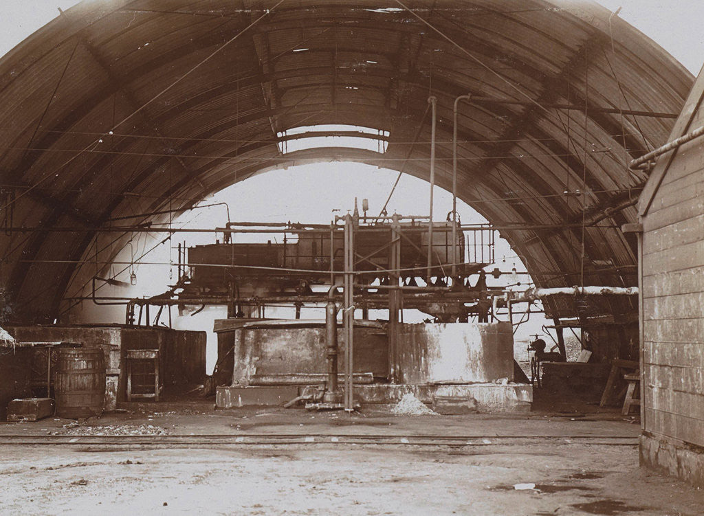 Detail of Interior of a half-round factory with a machine and pipe lines by Anonymous