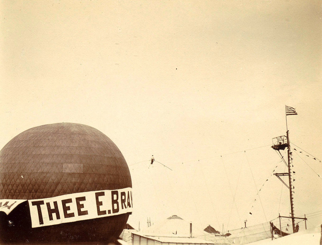 Detail of air balloon advertising for 'Tea E Brandsma in the background a tightrope walker over a fairground by Anonymous