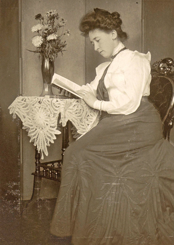Detail of Book Reading woman sitting at a table with a vase of flowers by Anonymous