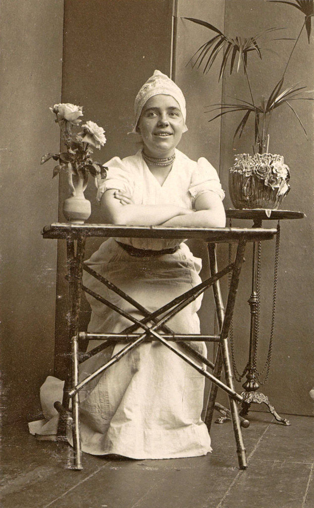 Detail of Woman with a maid's cap on, sitting at a table with flowers by Anonymous