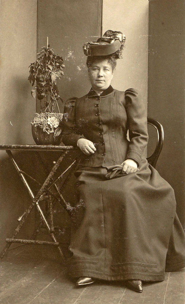 Detail of Woman with a hat, sitting next to a table with a plant by Anonymous