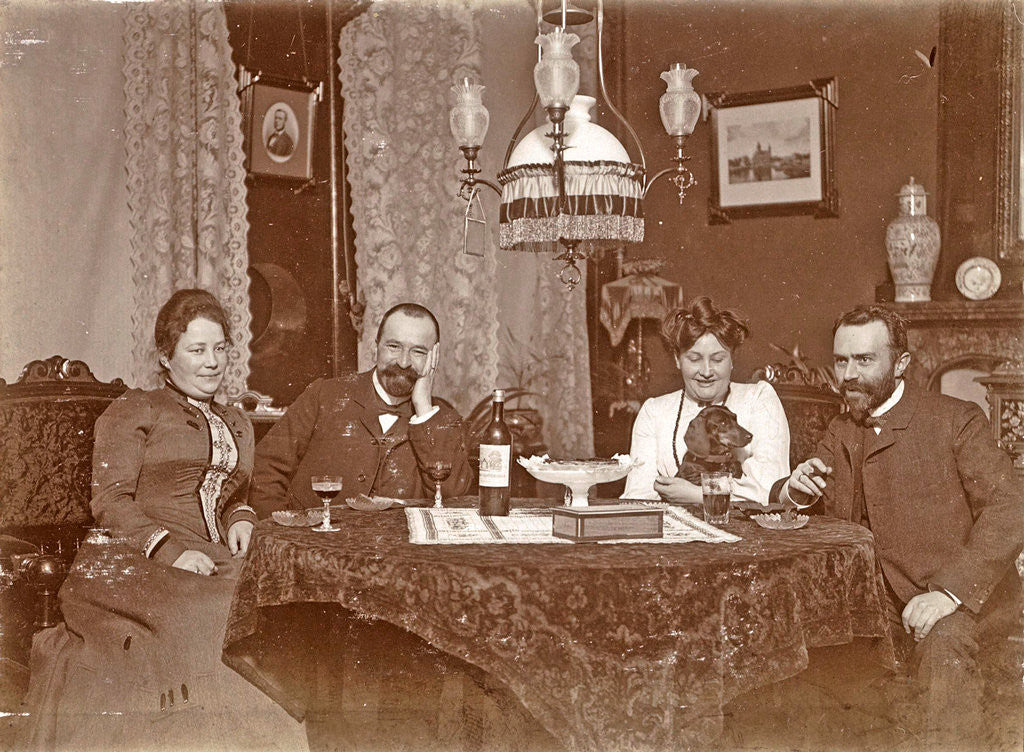 Detail of Two men and two women sitting around a table with glasses of wine by Anonymous