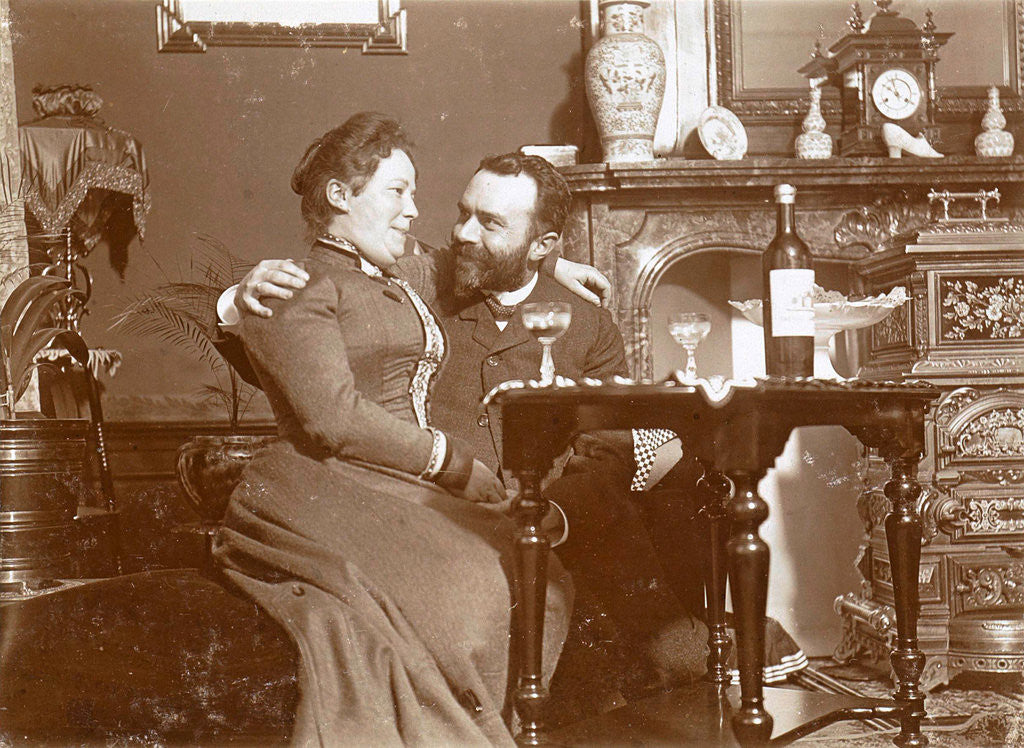 Detail of Woman on a man's lap with glass of wine in a living room by Anonymous