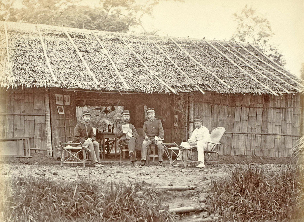 Detail of Dutch soldiers sitting in front of a wooden house in the Dutch East Indies by Anonymous