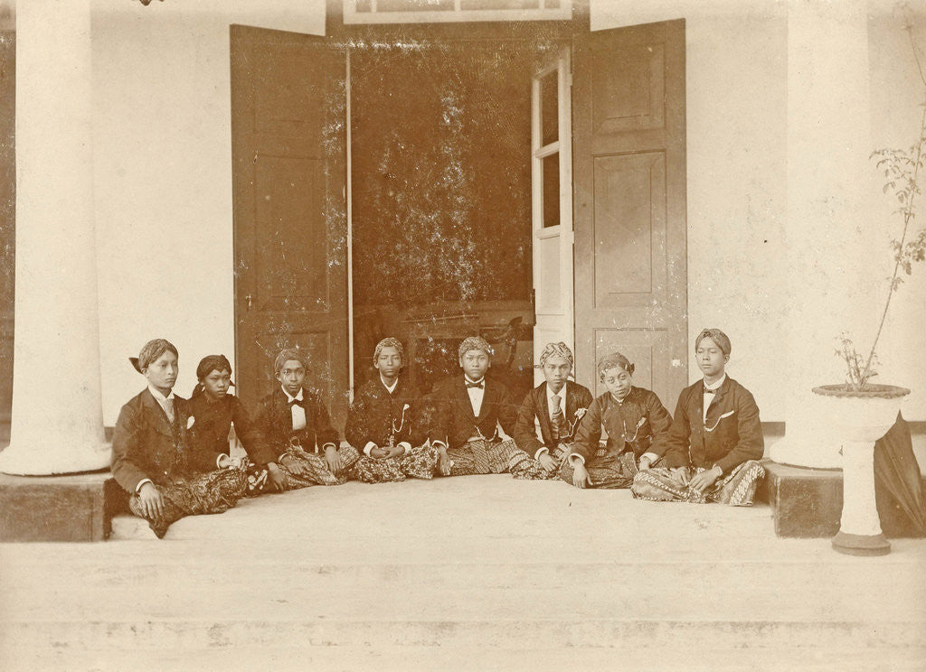 Detail of Eight Indian young men sat on the floor at an entrance in the Dutch East Indies by Anonymous