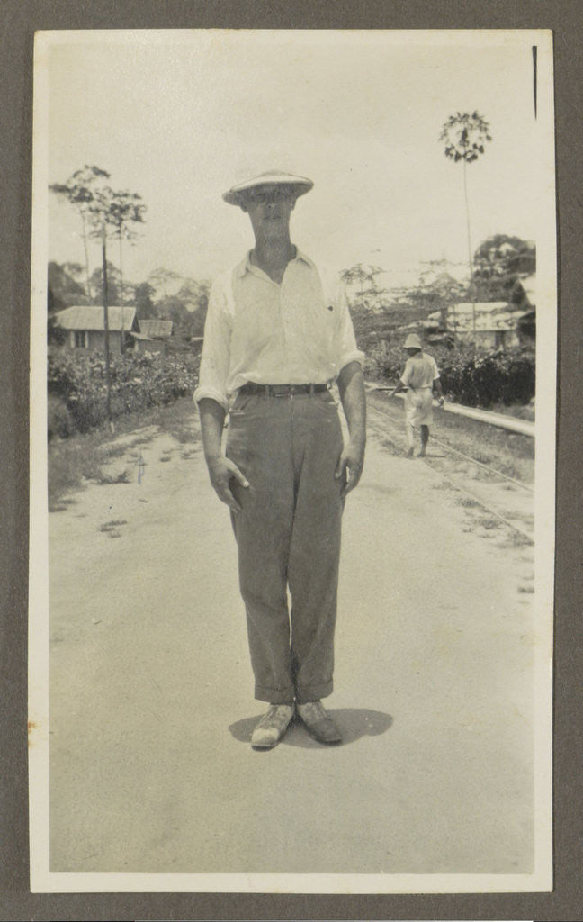 Detail of Man wearing a pith helmet posing on a road by Anonymous