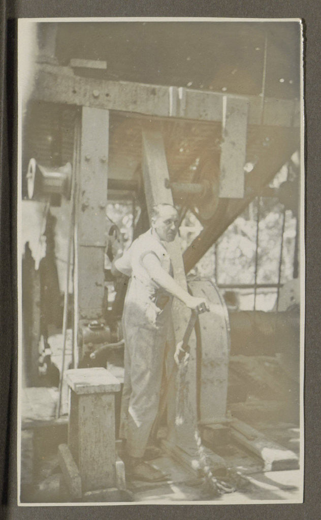 Detail of Man operating a machine with a lever by Anonymous