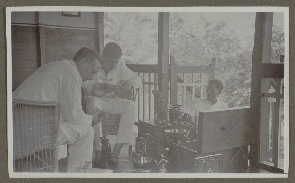 Detail of Two men view the wares of an Indian vendor by Anonymous