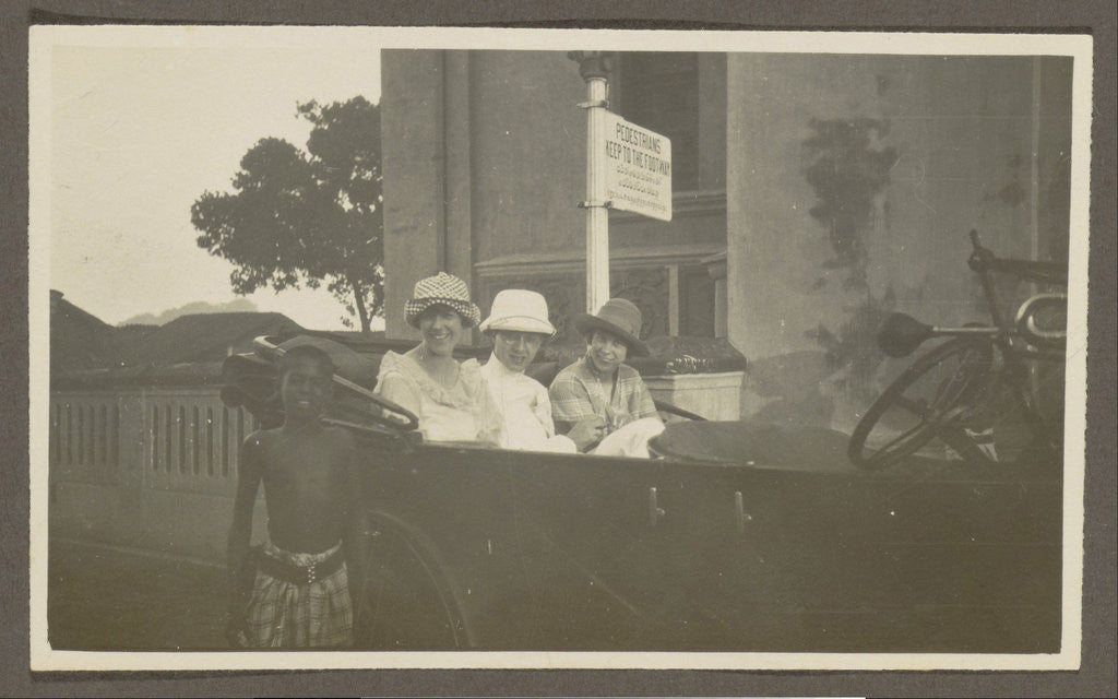 Detail of Triad sitting in the backseat of a car, leading a boy by Anonymous